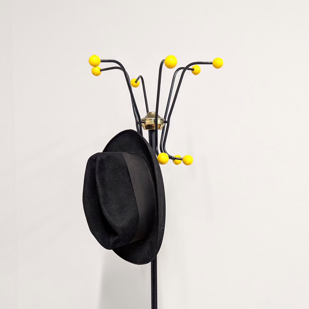 About as retro as it gets, these vintage 'atomic' 1960s coat stands are a load of fun. This one by Hago is particularly striking because of the yellow plastic and black metal combination. Designed to accommodate hats and coats at the top and umbrellas and walking sticks at the bottom, they are actually very practical stationed in an entrance hall. Great complete order (often the round drip cups in the base are long gone) and ready to make a statement.