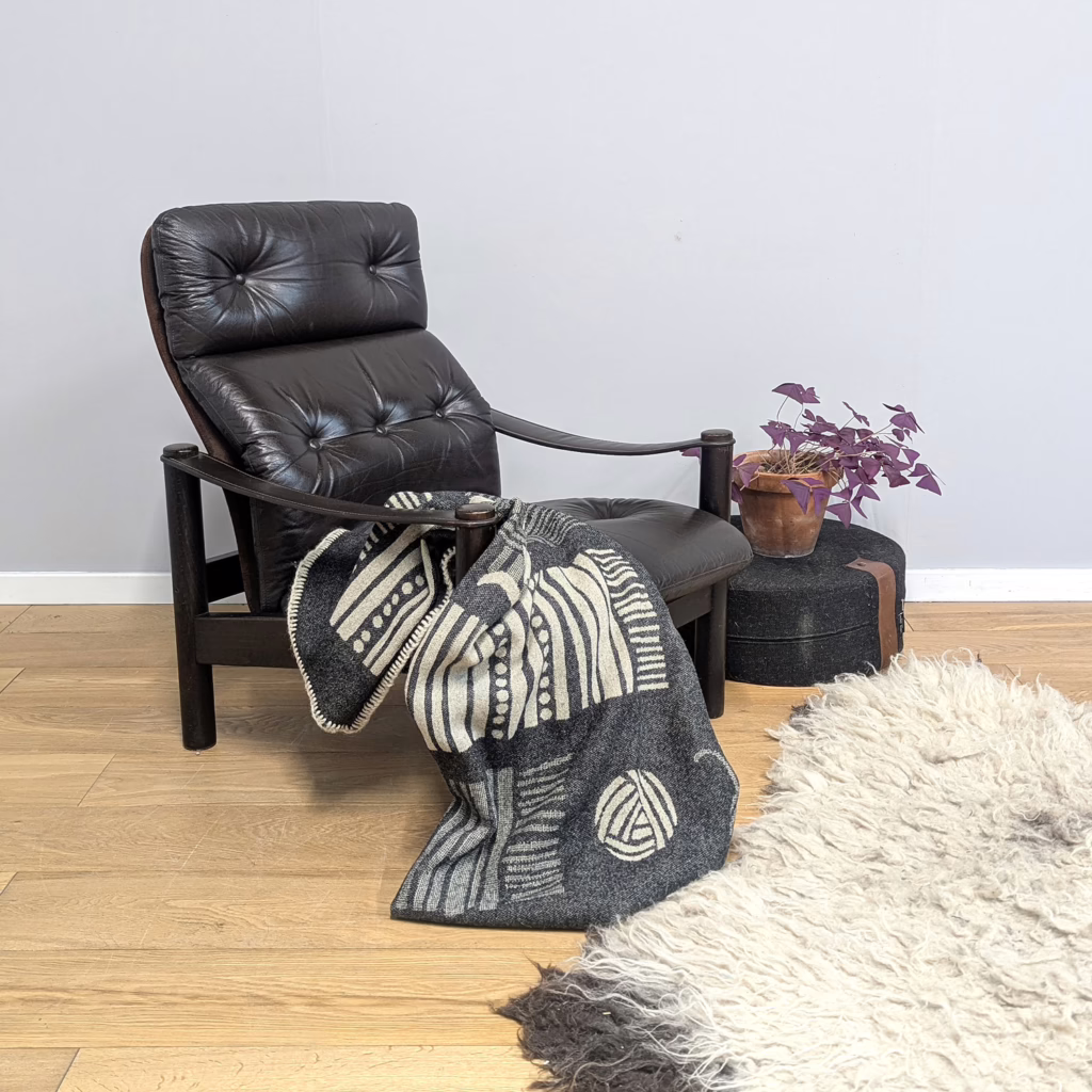 A statement lounge chair that's low, laidback and masculine, it originates from 1970's Denmark, designed by Ebbe Gehl and Søren Nissen for renowned maker, Jeki Mobler Bramming. The chunky, tubular, modernist frame in stained solid beech looks grand with the deep chocolate brown leather that's so dark it looks black at first glance. And comfort is as important as the good looks here. From the tilt (which can be adjusted) to the contoured suede back to the plump cushions to the generous proportions, this is an indulgent seat for someone who tales relaxing seriously. It’s rare to find a chair like this in such good condition – just light signs of wear and tear adding to its aged, vintage appeal in our view.