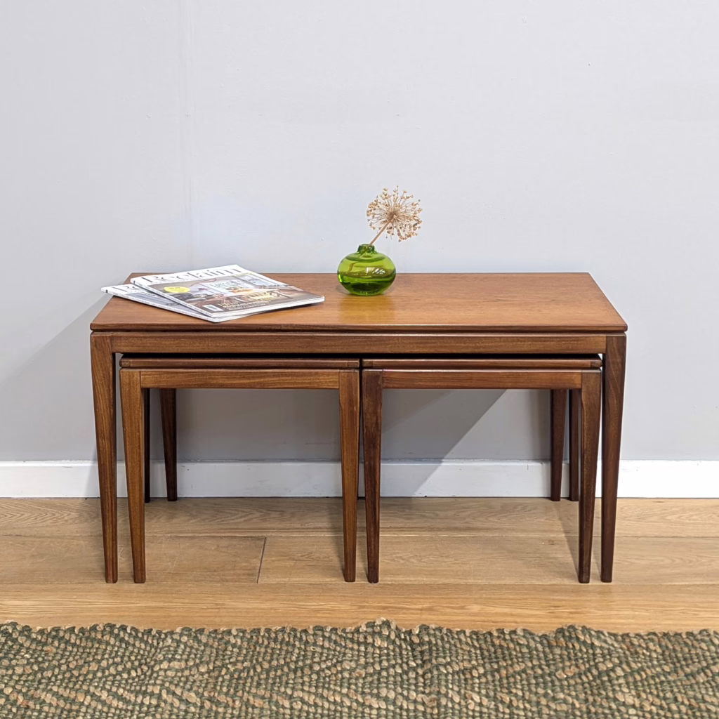 This trio of side tables is a catch. Dating from the mid 1960s, this set was designed by Richard Hornby for Fyne Ladye. There is a long, rectangular 'mother' table with two square occasional tables stowed neatly underneath. The overall design is elegant and slimline with slender legs set right at the corners. As you would expert from Hornby, they are crafted wonderfully well in afromosia. These table nests are always useful in main living spaces, to be deployed when additional surfaces are required then tucked away when not in use. Practical and handsome in equal measure.