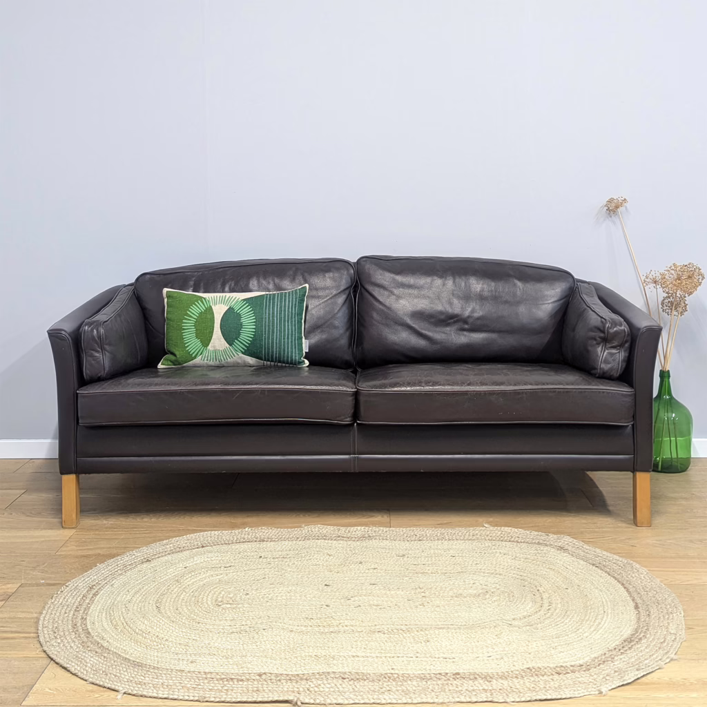 A design evolution of the more commonly seen sharp-lined, chiselled Scandinavian sofas is this gently curvaceous couch. It's a prestige, high-end piece by Danish manufacturer, Mogens Hansen. We feel it would be remise to call it a 2.5 seater as at its widest point it's over 1.9m, so amply a standard three seater. But the curves and the design with two large seat and back cushions, rather than three, create an illusion of a smaller sofa. And it's so very handsome. From the arcing back to the open curves of the arms, it feels inviting and refined in equal measure. Supremely comfortable with plump, generous cushions surrounding you, it would make a stylish, sophisticated main lounge sofa.