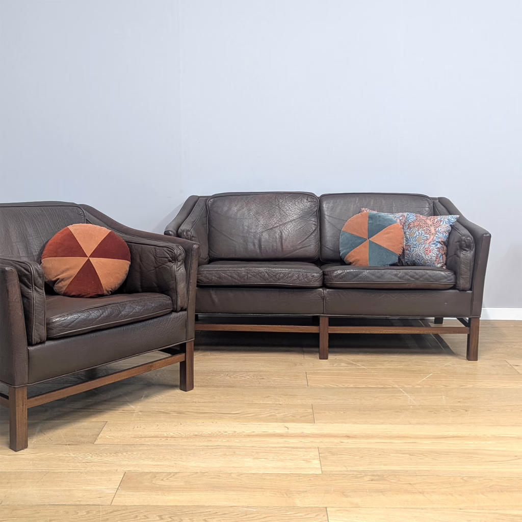 Here's a classic, midcentury Danish lounge set comprised of a matching two seater sofa and armchair, both unfussy, super stylish and looking great from all angles. Attributed to Georg Thams, he designed this range in collaboration with Grant Møbelfabrik in the first half of the seventies. They are in their original mid-brown leather, the upholstery is lightly lived in, rugged and hard-wearing, getting more characterful and better with age and use. We love the gentle contours of the sides and arms which soften what might otherwise be a boxy, austere silhouettes. They sit on rosewood bases which complements the leather tones perfectly. Comfort is a tricky thing to describe as its so subjective but we would say the sofa and chair as 'medium firm'.

The sofa and chair are available for purchase separately - see their individual listings.

&nbsp;