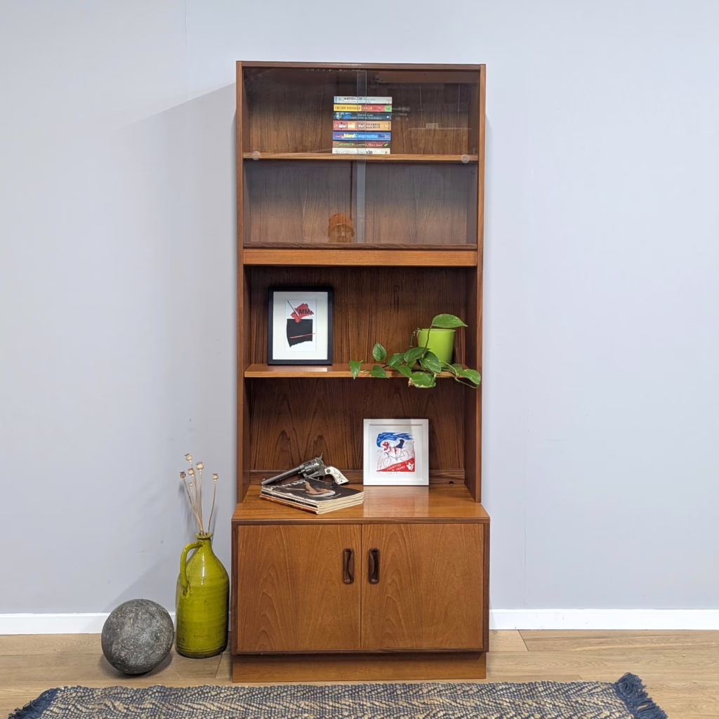 Designed by VB Wilkins for G Plan, as part of his late 1960s / early 1970s Fresco range, this freestanding, multi-functional unit serves as storage and display space in one handsome piece. Tall but shallow in depth and tidy in width, it would work well in a small room where going up is better than going wide. This particular set up features an upper glazed bookcase, an open shelf and a lower cupboard with the signature Fresco handles.  It's a two-part piece with the upper section sitting on the deeper base. These versatile units offer more flexibility than built-in shelves and are great in alcoves or those recesses next to a chimney breast.

&nbsp;