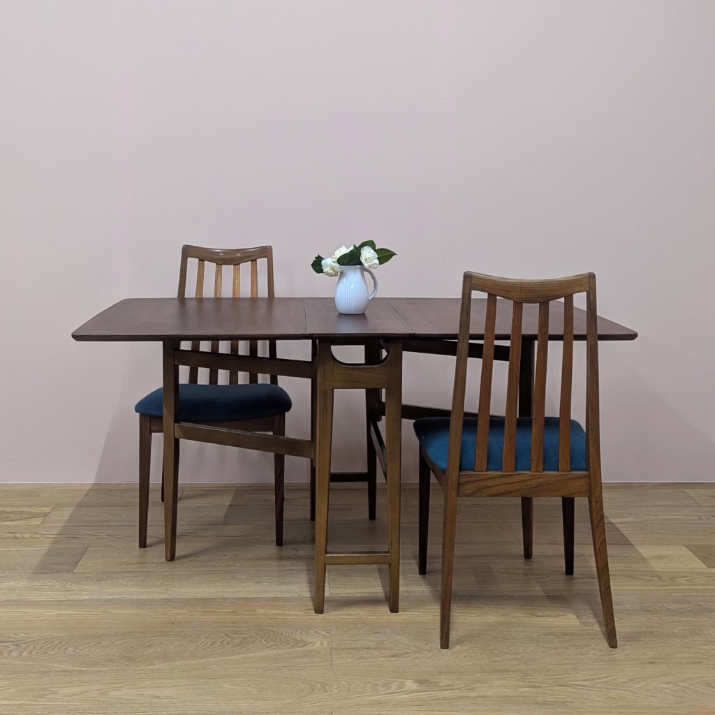 This space-saving table is perfect for small rooms. Fully extended, you have a generous, rectangular, teak dining table with classic, midcentury good looks for up to six diners and when not in use, the two leaves fold down to very compact proportions to tuck away neatly against the wall. Made by British furniture maker, Jentique, its construction is quality, the gate legs swinging out with ease to extend one side or both. And the table is in fantastic order. It's clearly been taken great care of. These folding, gate leg tables are also good supplementary pieces for those times when lots of people are around - parties, Christmas, Easter. It can be easily set up for the occasion but then stowed away until the next big gathering.

&nbsp;